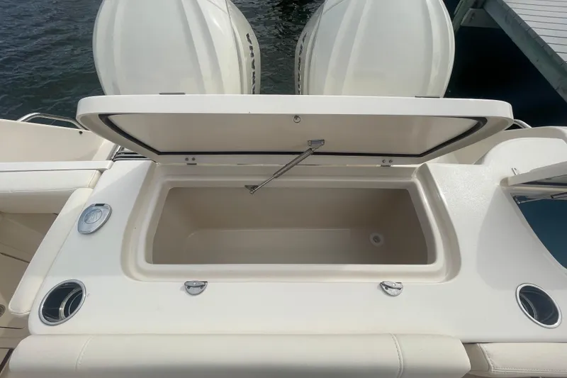Slide: The Image of Open storage compartment on 2026 Grady-White Freedom 307 boat, docked by the water. - 25