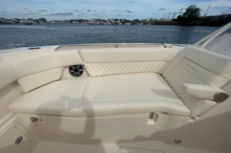 Slide: The Image of Luxury seating on 2026 Grady-White Freedom 307 boat, with waterfront view. - 9