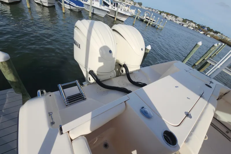Slide: The Image of 2026 Grady-White Canyon 271 boat with Yamaha engines docked at marina. - 11