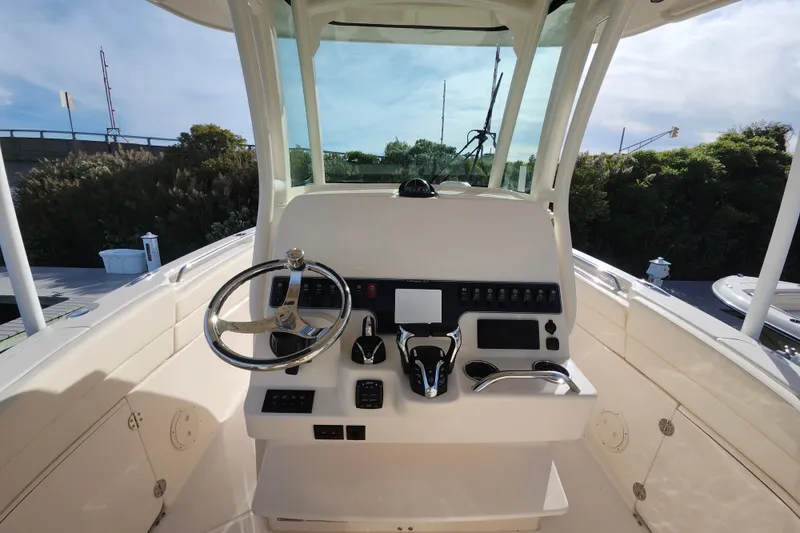 Slide: The Image of Helm of 2026 Grady-White Canyon 271 boat with modern controls and steering wheel. - 2