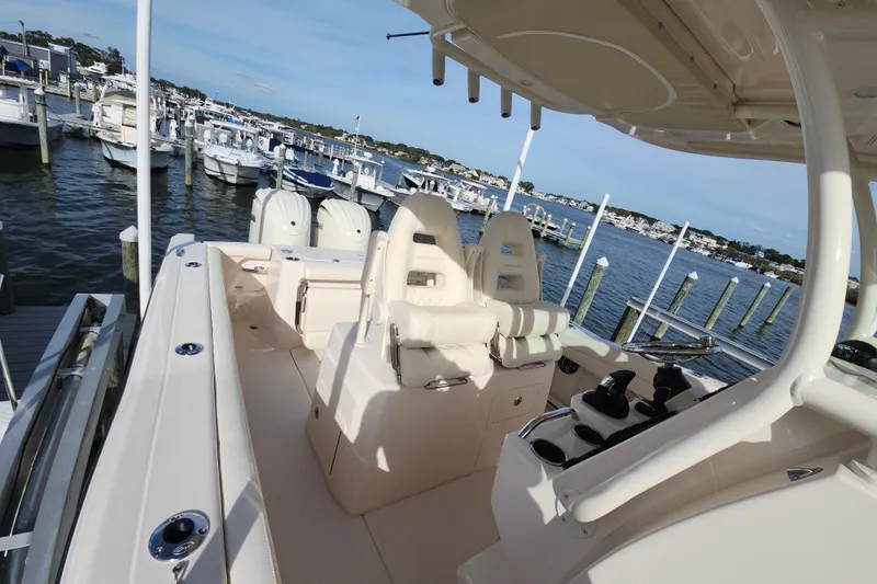 Slide: The Image of 2026 Grady-White Canyon 271 boat docked at marina, featuring spacious seating and helm. - 6