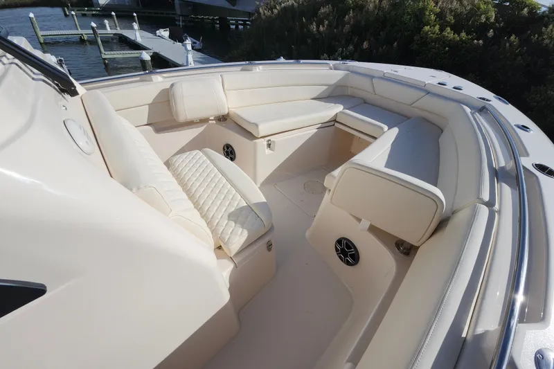 Slide: The Image of 2026 Grady-White Canyon 271 boat interior with cushioned seating and speakers. - 7
