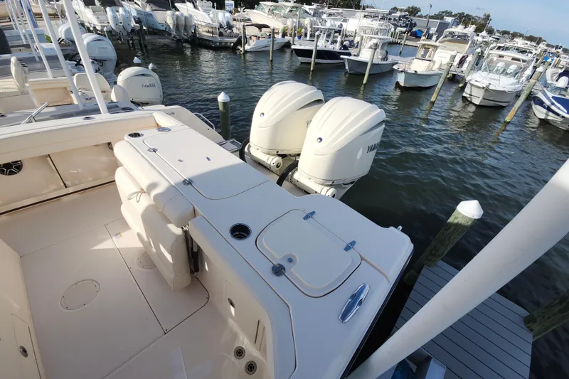 Slide: The Image of 2026 Grady-White Canyon 271 boat with twin Yamaha engines docked at marina. - 9