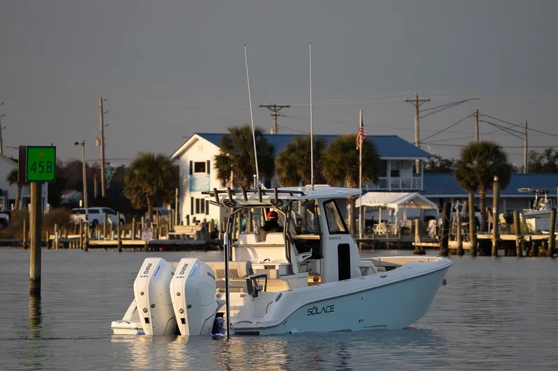 The Image of 2026 Solace 30 HCS boat on trailer, parked outdoors with trees in background. - 0