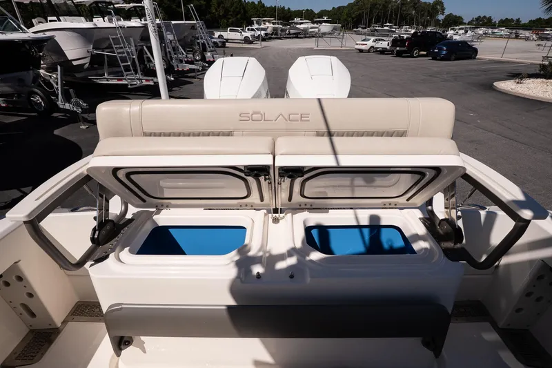 Slide: The Image of 2026 Solace 30 HCS boat on calm water near a marina at sunset. - 10