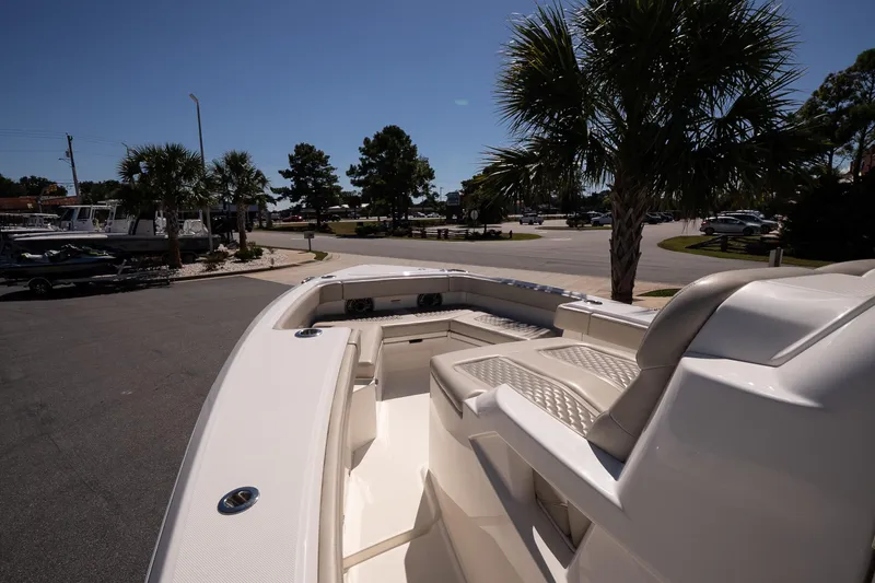 Slide: The Image of 2026 Solace 30 HCS boat with open storage compartments, parked in a marina. - 19