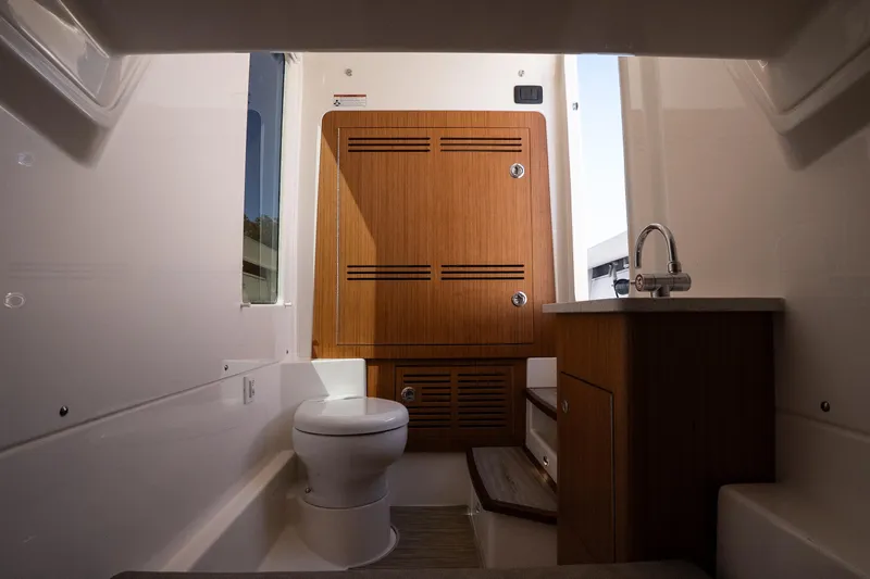 Slide: The Image of Luxurious bathroom interior of 2026 Solace 30 HCS boat, featuring modern fixtures and wooden cabinetry. - 32