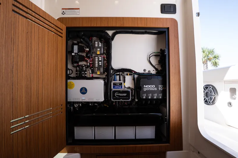 Slide: The Image of Electrical panel inside 2026 Solace 30 HCS boat, featuring NOCO Genius charger. - 34