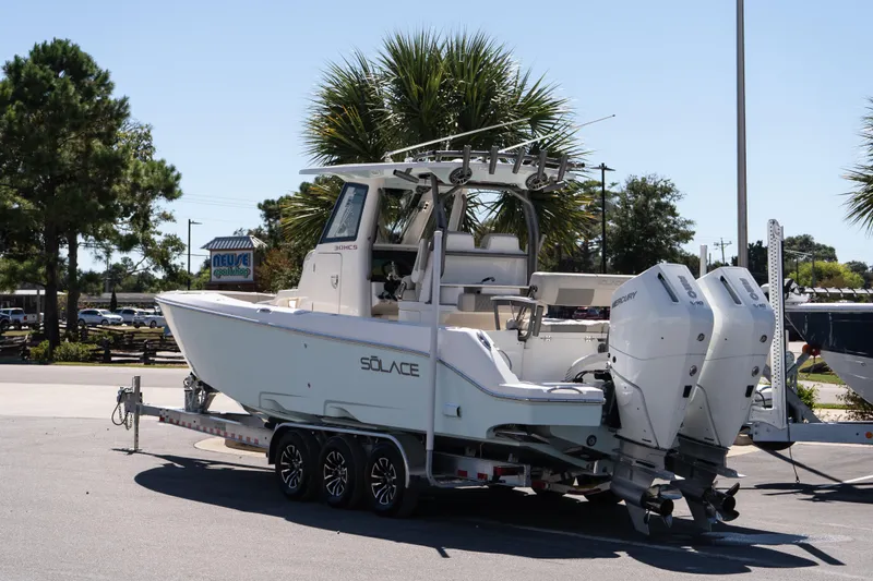 Slide: The Image of 2026 Solace 30 HCS boat on calm water near coastal buildings. - 4