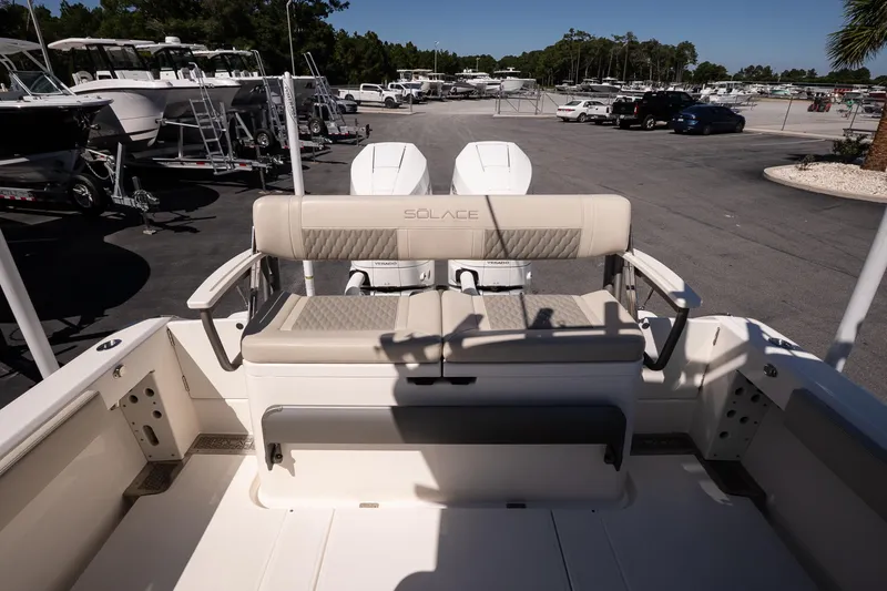 Slide: The Image of 2026 Solace 30 HCS boat on calm water, with a coastal town backdrop at sunset. - 9