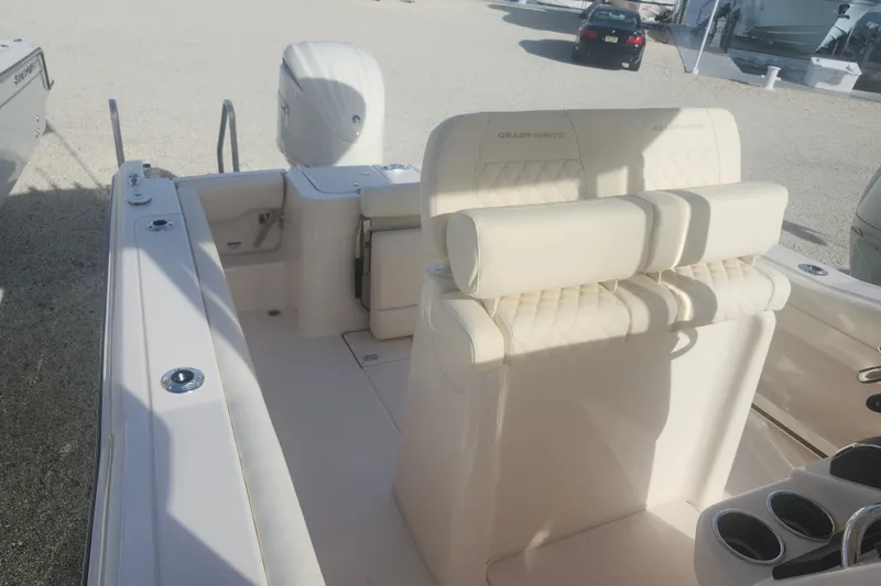 Slide: The Image of 2026 Grady-White Fisherman 236 boat interior with cushioned seating and engine view. - 4