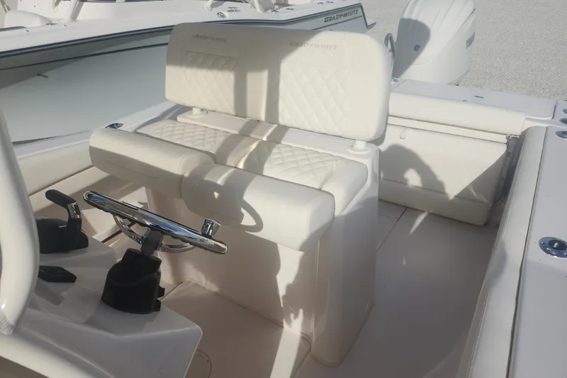 Slide: The Image of 2026 Grady-White Fisherman 236 boat interior with white seating and steering console. - 5