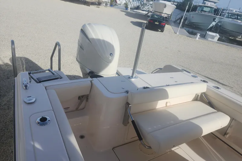 Slide: The Image of 2026 Grady-White Fisherman 236 boat with Yamaha outboard engine, docked on gravel. - 6