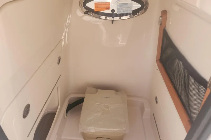 Slide: The Image of 2026 Grady-White Fisherman 236 interior cabin with storage and portable toilet. - 7