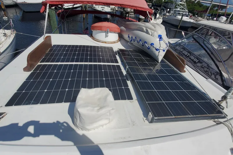 Slide: The Image of 1988 Sundowner Tug 30 with solar panels on deck, docked at marina. - 10