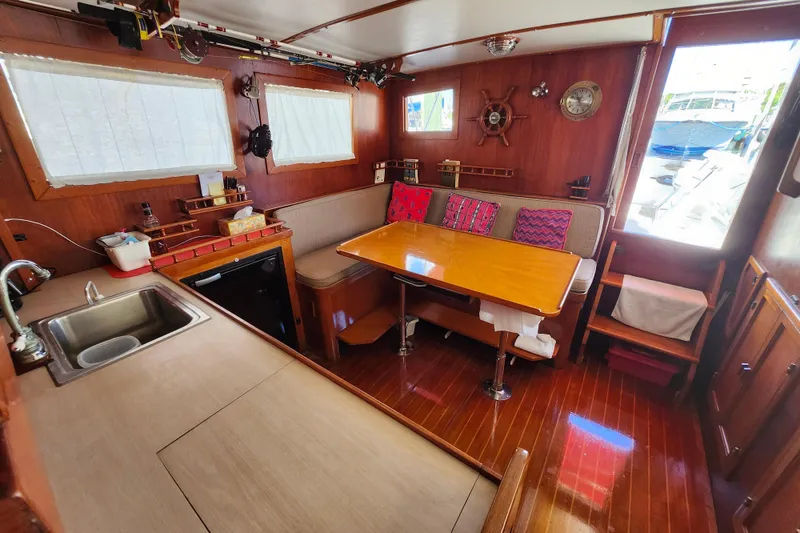 Slide: The Image of Interior of 1988 Sundowner Tug 30 with cozy dining area and wooden decor. - 14