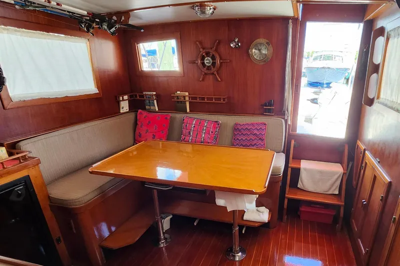 Slide: The Image of Interior of 1988 Sundowner Tug 30 with wooden decor and cozy dining area. - 15