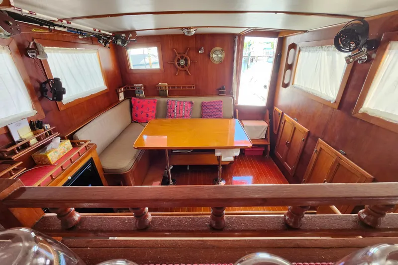 Slide: The Image of Cozy 1988 Sundowner Tug 30 interior with wooden decor and dining area. - 16