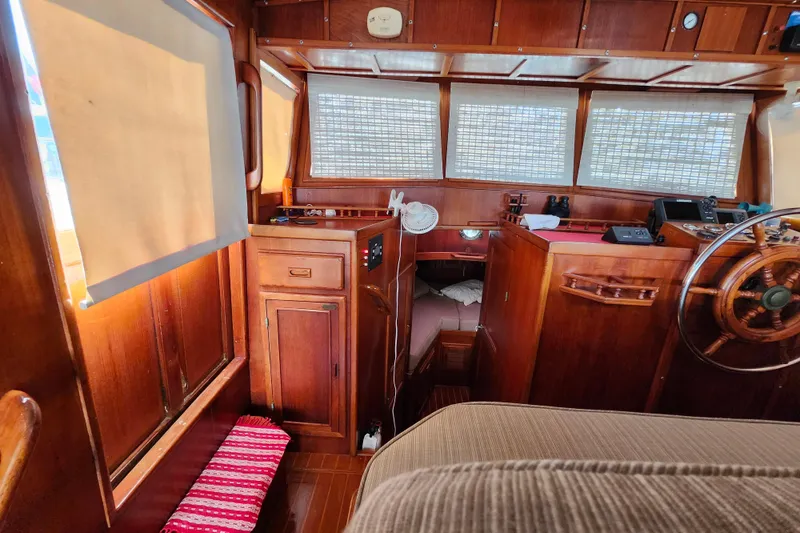 Slide: The Image of Interior of 1988 Sundowner Tug 30 with wooden finish and nautical decor. - 19