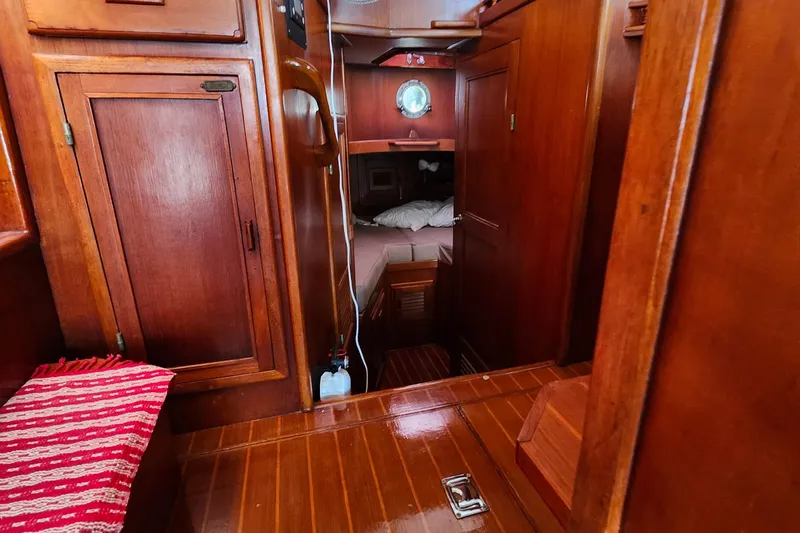 Slide: The Image of Interior of 1988 Sundowner Tug 30, featuring wooden cabinetry and cozy sleeping quarters. - 20
