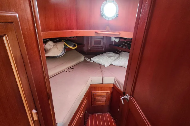 Slide: The Image of Cozy cabin interior of 1988 Sundowner Tug 30 with wooden finish and porthole. - 21