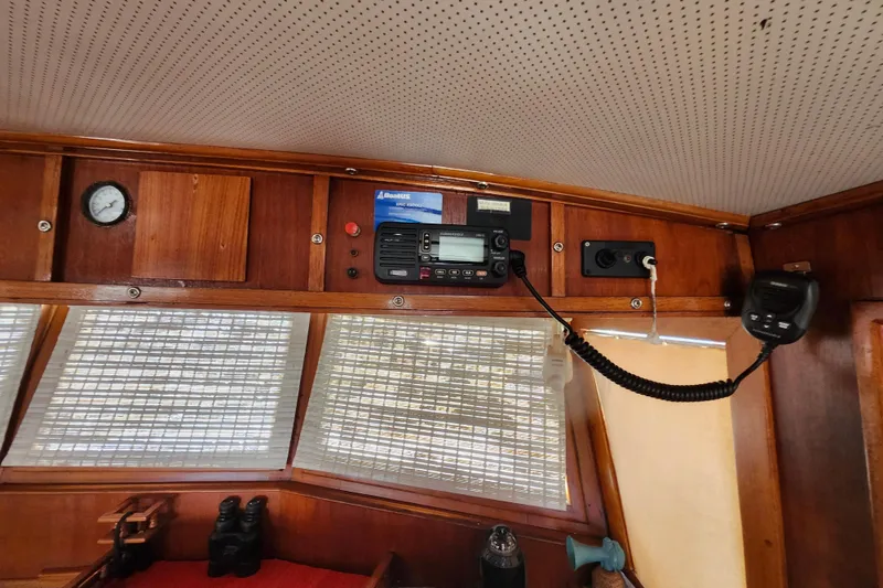 Slide: The Image of Interior of 1988 Sundowner Tug 30 with radio equipment and wooden paneling. - 24