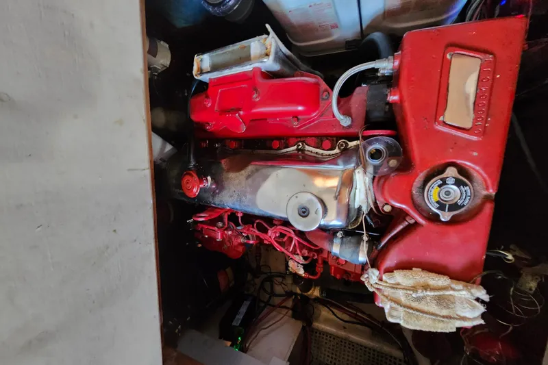 Slide: The Image of Engine compartment of a 1988 Sundowner Tug 30, featuring a red engine block. - 29
