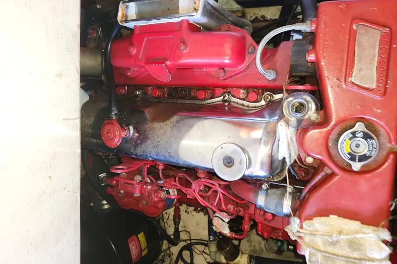 Slide: The Image of Engine of a 1988 Sundowner Tug 30, featuring red components and visible wiring. - 30