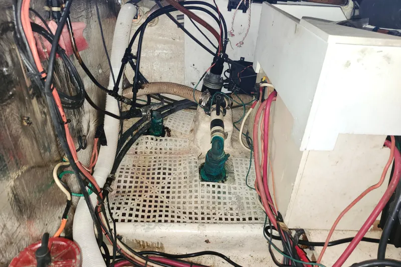 Slide: The Image of Engine compartment of a 1988 Sundowner Tug 30 with visible wiring and hoses. - 31