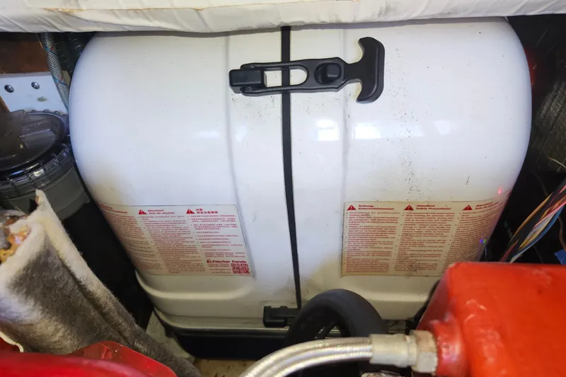 Slide: The Image of Engine compartment of a 1988 Sundowner Tug 30 with visible generator and components. - 32