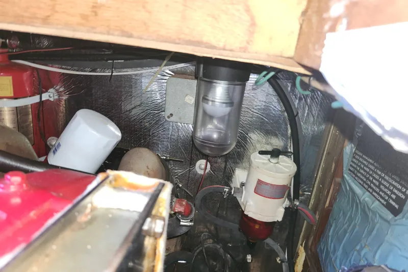 Slide: The Image of Engine compartment of a 1988 Sundowner Tug 30, showing filters and wiring. - 33