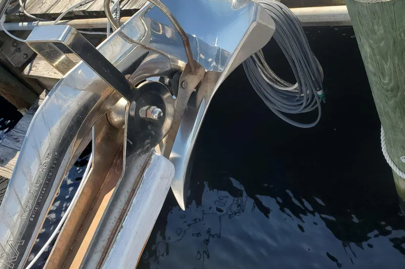 Slide: The Image of Anchor of 1988 Sundowner Tug 30 boat, docked with coiled rope visible. - 4