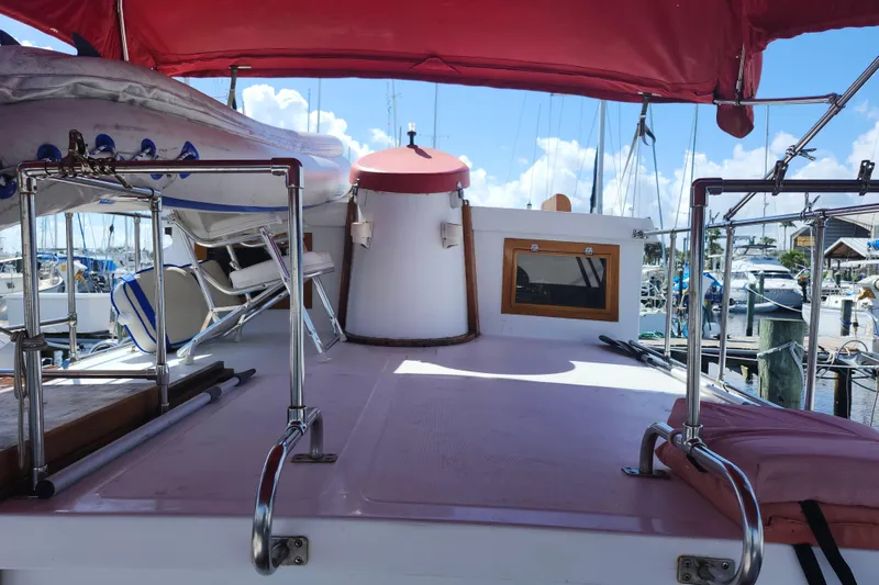 Slide: The Image of 1988 Sundowner Tug 30 boat deck with red canopy and marina view. - 5