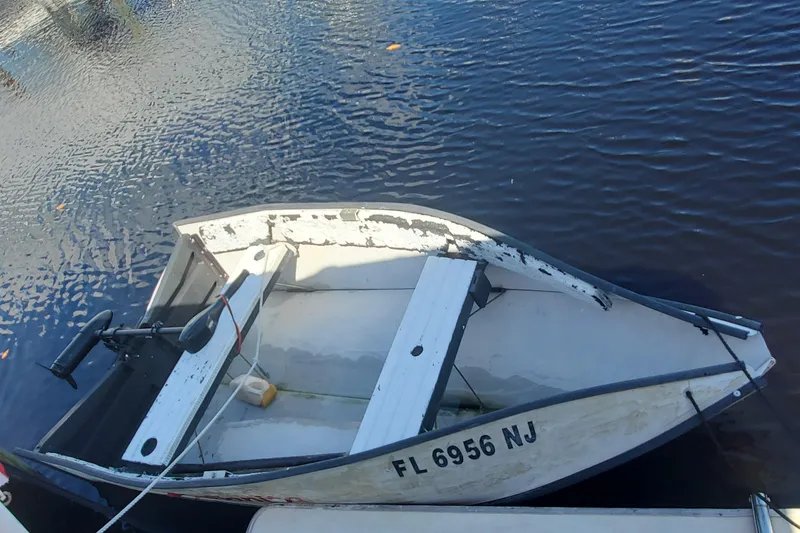 Slide: The Image of Small white boat on calm water, Sundowner Tug 30, 1988 model. - 8