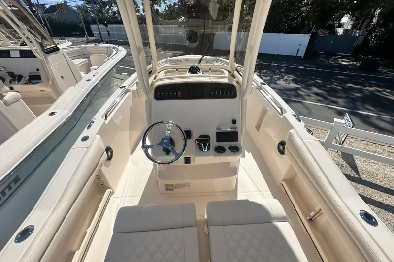 Slide: The Image of 2026 Grady-White Fisherman 216 boat interior with steering wheel and control panel. - 10