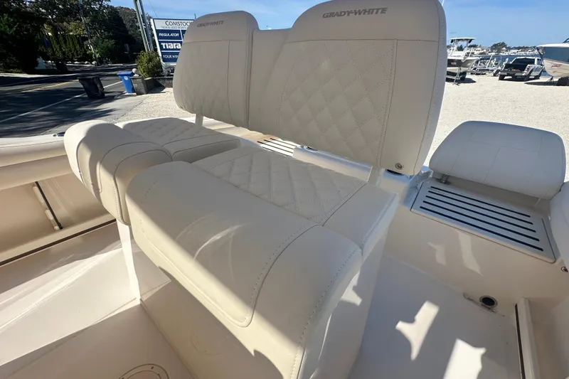 Slide: The Image of 2026 Grady-White Fisherman 216 boat interior with cushioned seating and diamond stitching. - 6