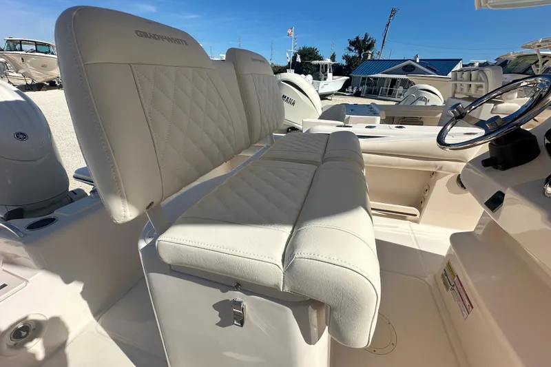 Slide: The Image of 2026 Grady-White Fisherman 216 boat interior with plush seating and steering wheel. - 7