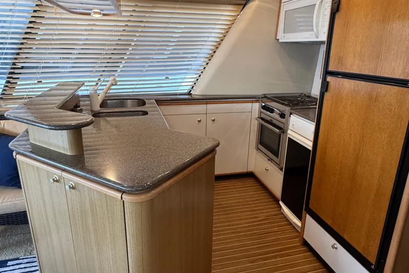 Slide: The Image of Luxurious kitchen interior of 2000 Bayliner 4788 Pilot House Motoryacht with modern appliances. - 16