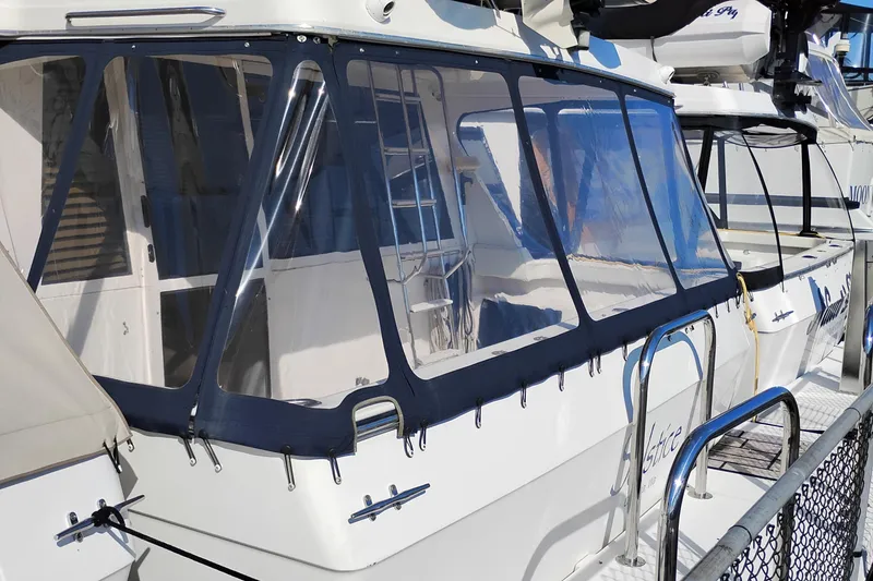 Slide: The Image of 2000 Bayliner 4788 Pilot House Motoryacht with enclosed cockpit at dock. - 2