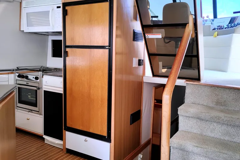 Slide: The Image of Interior of 2000 Bayliner 4788 Pilot House Motoryacht with kitchen and stairs. - 20