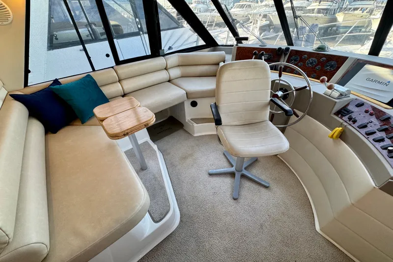 Slide: The Image of 2000 Bayliner 4788 Pilot House Motoryacht interior with helm, seating, and navigation equipment. - 21