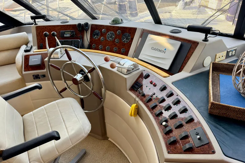 Slide: The Image of 2000 Bayliner 4788 Pilot House Motoryacht helm with Garmin navigation system and control panel. - 23