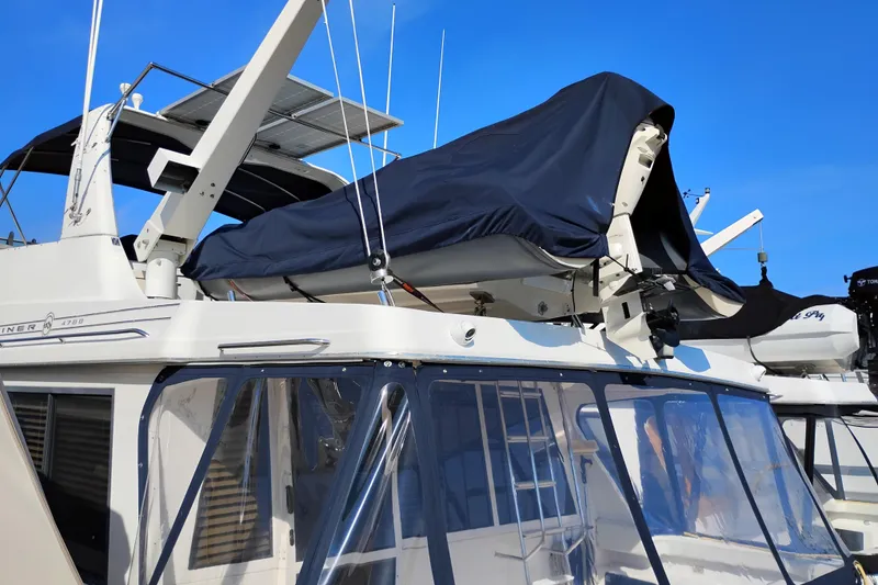 Slide: The Image of 2000 Bayliner 4788 Pilot House Motoryacht with covered upper deck and clear windows. - 3