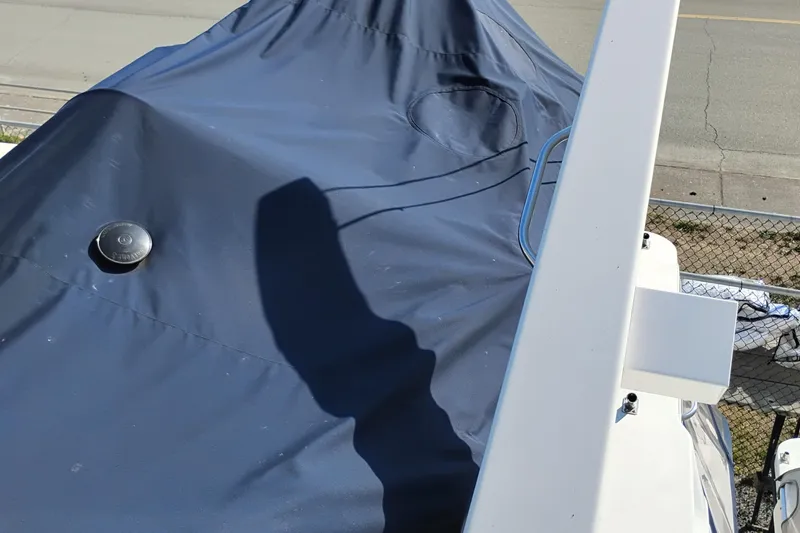 Slide: The Image of Bayliner 4788 Pilot House Motoryacht 2000 with blue cover and visible railing. - 34