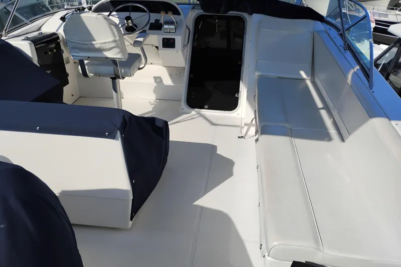 Slide: The Image of 2000 Bayliner 4788 Pilot House Motoryacht interior with helm and seating area. - 37
