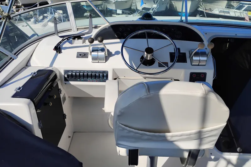 Slide: The Image of Cockpit of 2000 Bayliner 4788 Pilot House Motoryacht with steering wheel and controls. - 38