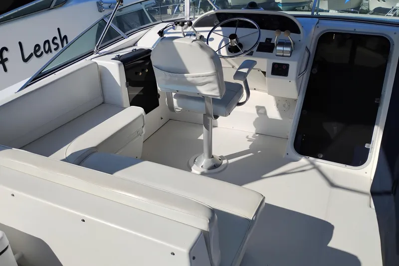 Slide: The Image of 2000 Bayliner 4788 Pilot House Motoryacht cockpit with steering wheel and seating. - 39