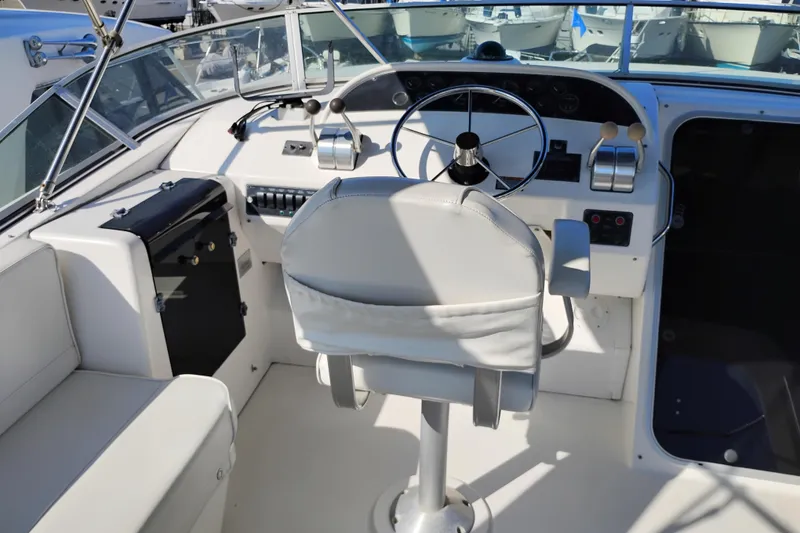 Slide: The Image of 2000 Bayliner 4788 Pilot House Motoryacht helm with steering wheel and controls. - 41