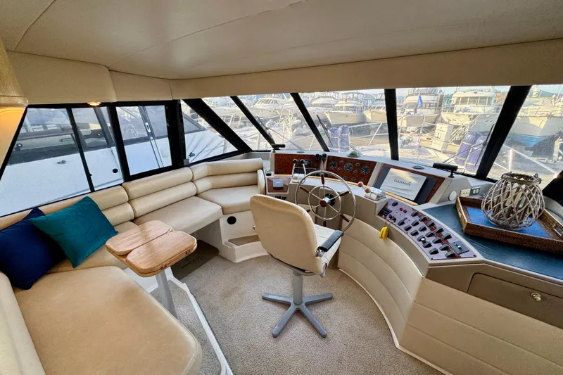 Slide: The Image of 2000 Bayliner 4788 Pilot House Motoryacht interior with helm, seating, and navigation equipment. - 42