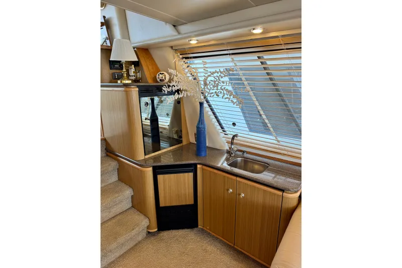 Slide: The Image of Luxurious interior of 2000 Bayliner 4788 Pilot House Motoryacht with elegant wood finish. - 43